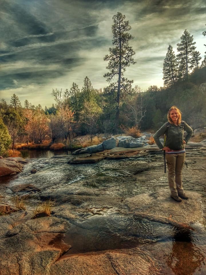 Nikki stands near a pretty stream in Arizona